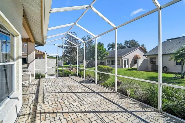 a view of a house with a big yard and potted plants