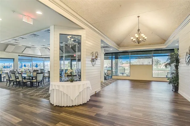 an entryway and livingroom with furniture wooden floor a chandelier