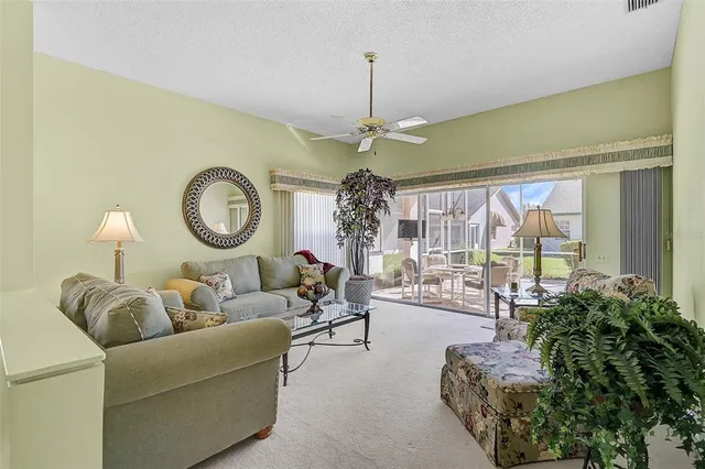 a living room with couches a large mirror with a large window with outer view