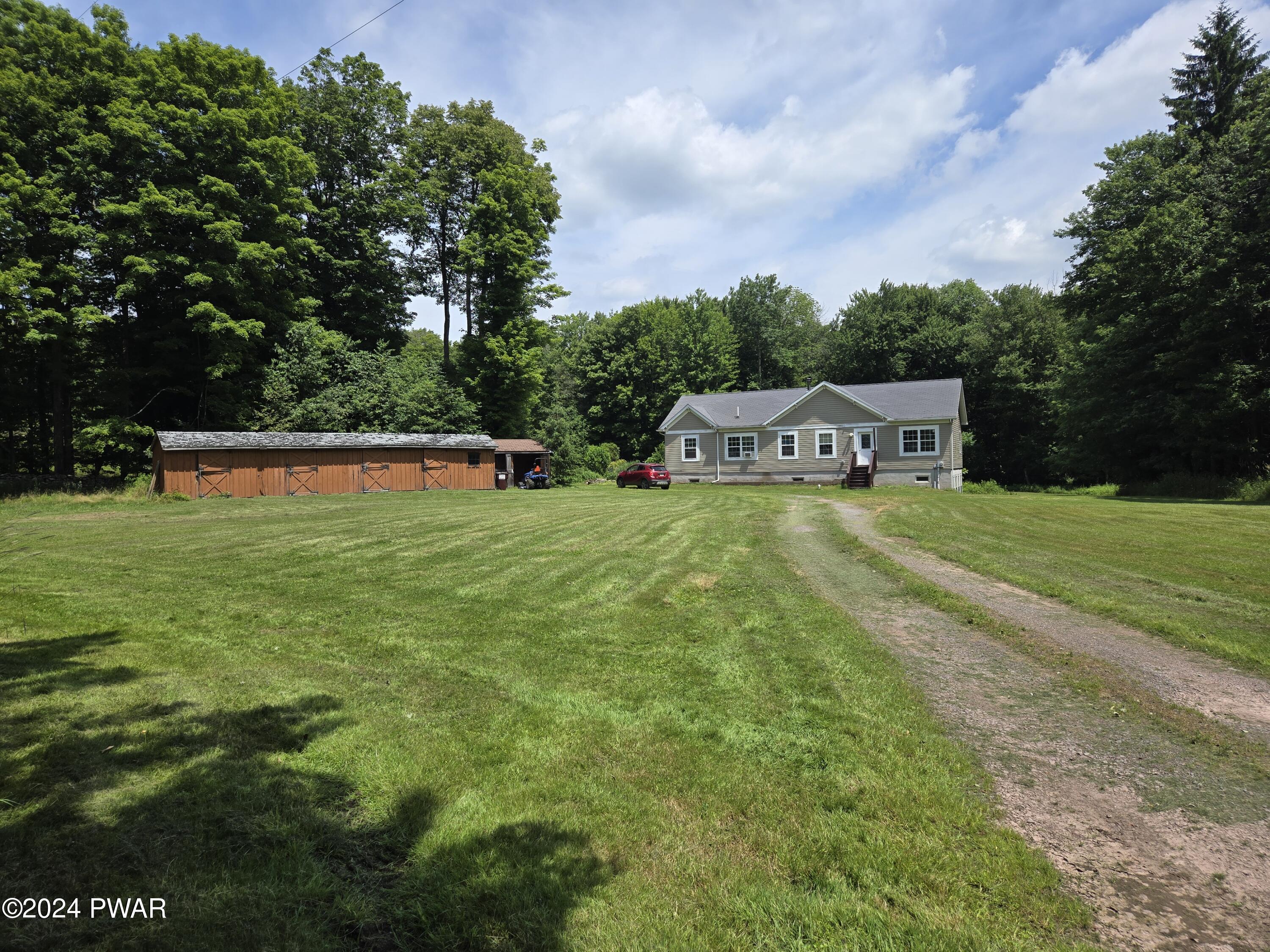 224 Old Racht Road Waymart, PA 18472 - Photo 3 of 39 a view of a house with swimming pool and yard