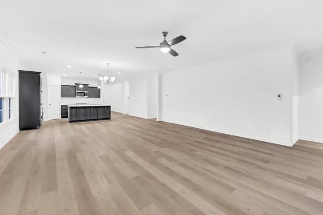 a view of a kitchen with a sink and a refrigerator