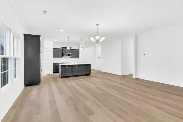 a view of a kitchen with a sink and a chandelier