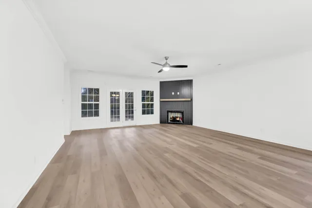 a view of empty room with a fireplace and a window