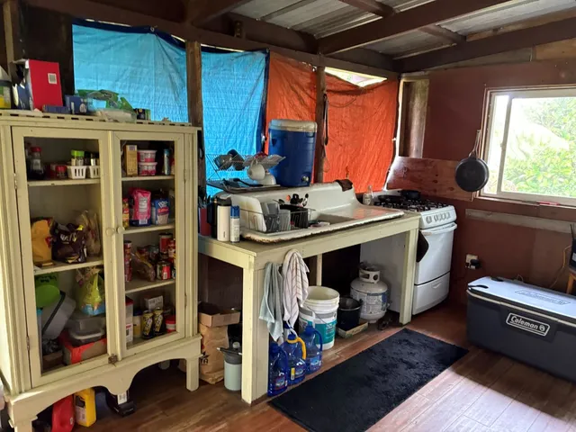 a view of open kitchen with cabinet and a fireplace