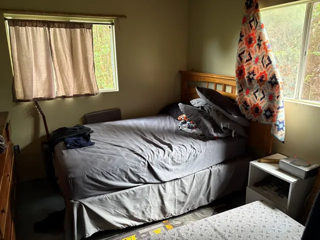 a bedroom with furniture and a window