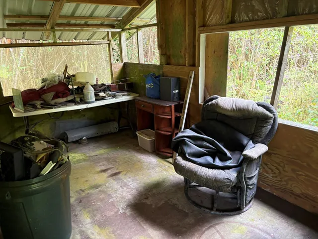 a view of a chairs and table in patio with a yard
