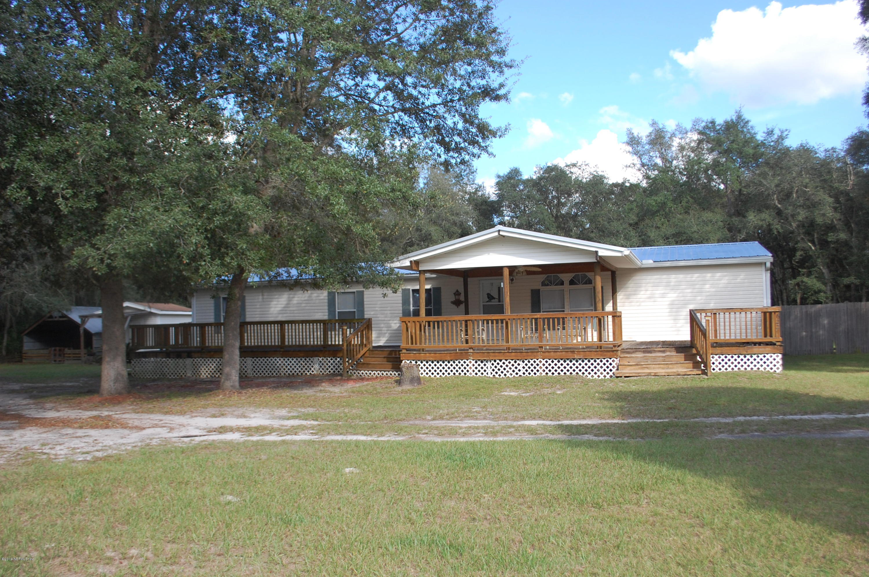 622 Lake Susan Road Hawthorne, FL 32640 - Photo 1 of 50 a backyard of a house with table and chairs