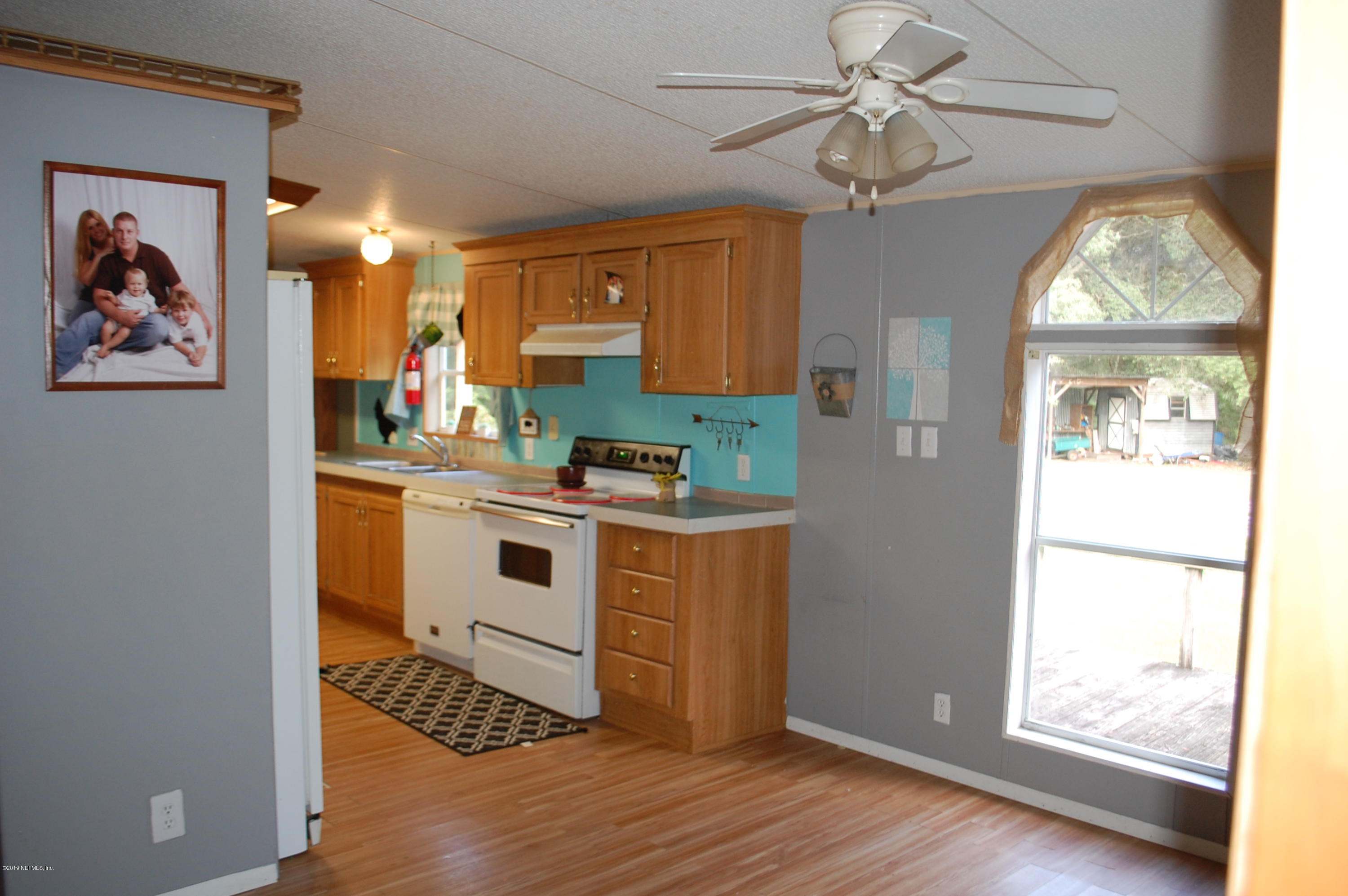 622 Lake Susan Road Hawthorne, FL 32640 - Photo 13 of 50 a view of kitchen with stainless steel appliances granite countertop a stove a sink and a refrigerator with wooden floor