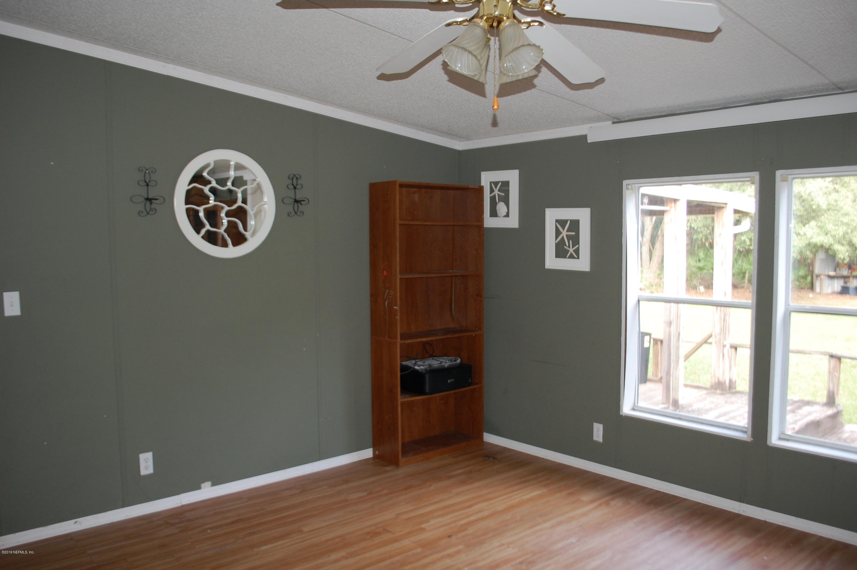 622 Lake Susan Road Hawthorne, FL 32640 - Photo 16 of 50 a view of an empty room with a window and wooden floor