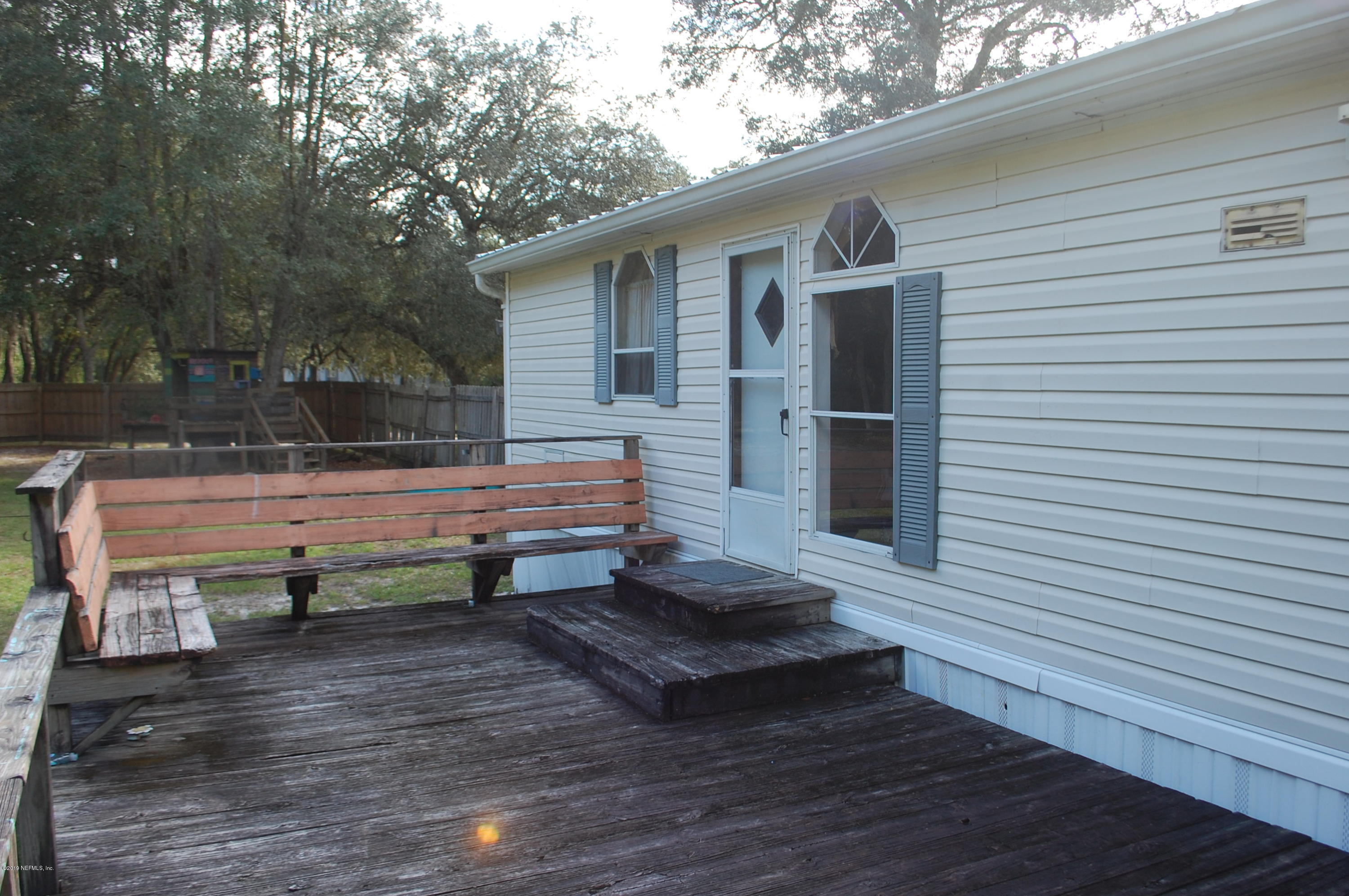622 Lake Susan Road Hawthorne, FL 32640 - Photo 47 of 50 a view of a chairs setting in the backyard of a house