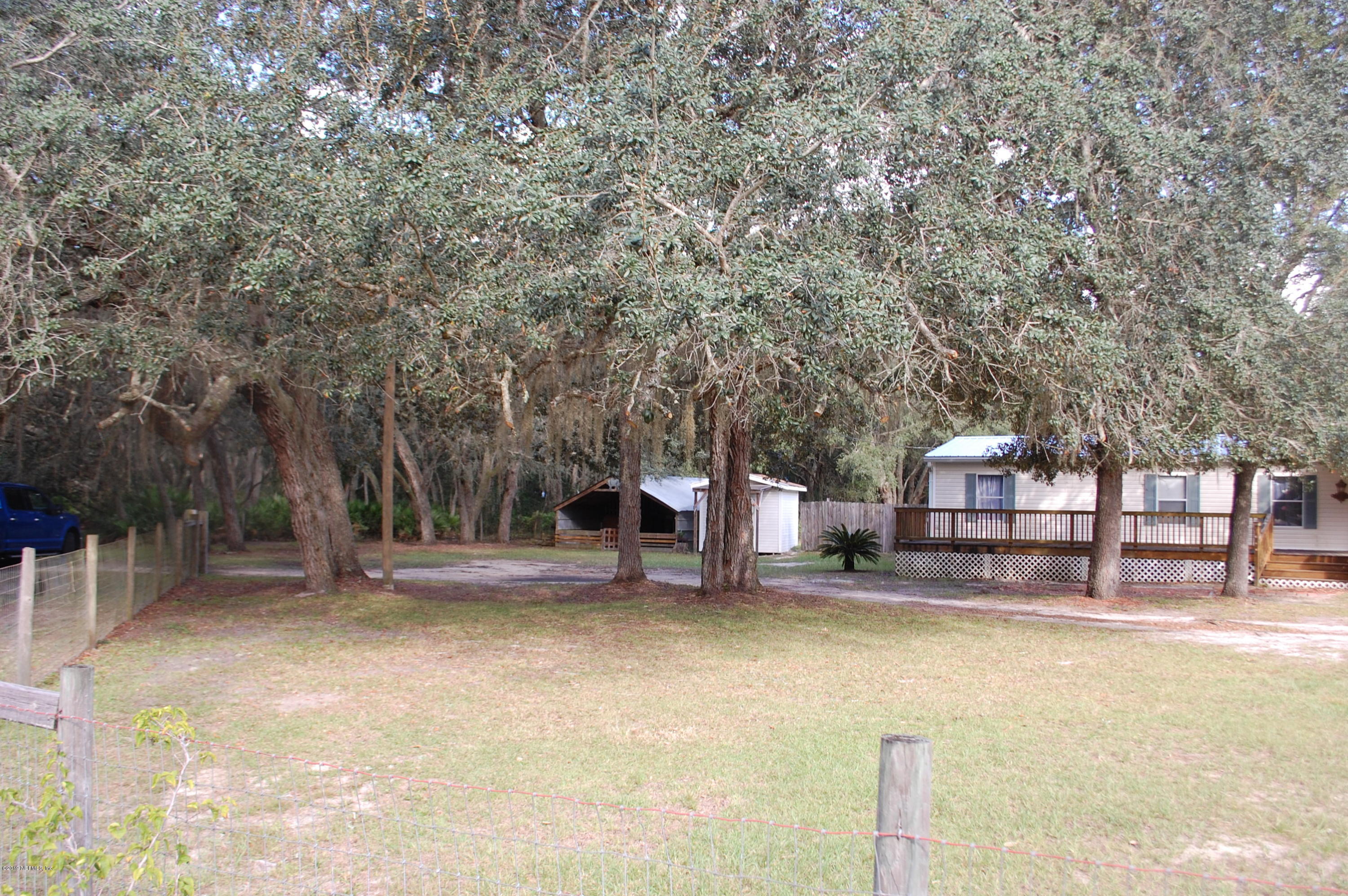 622 Lake Susan Road Hawthorne, FL 32640 - Photo 8 of 50 a backyard of a house with fountain table and chairs