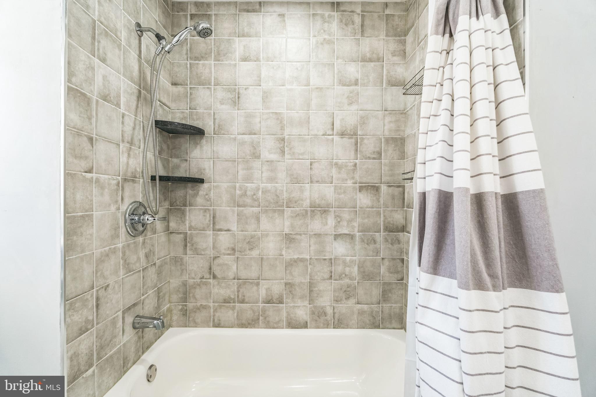 855 Medway Road Philadelphia, PA 19115 - Photo 16 of 30 a bathroom with a bathtub and shower