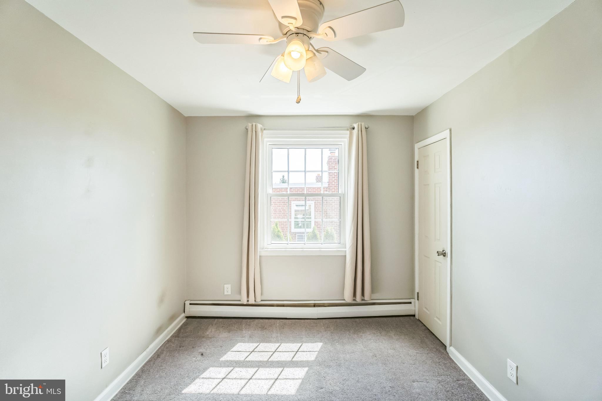855 Medway Road Philadelphia, PA 19115 - Photo 19 of 30 an empty room with chandelier fan and windows