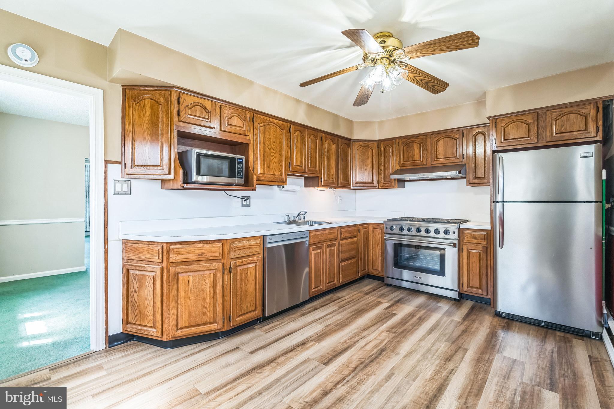 855 Medway Road Philadelphia, PA 19115 - Photo 8 of 30 a kitchen with stainless steel appliances granite countertop a refrigerator a stove a sink dishwasher and a microwave oven with cabinets