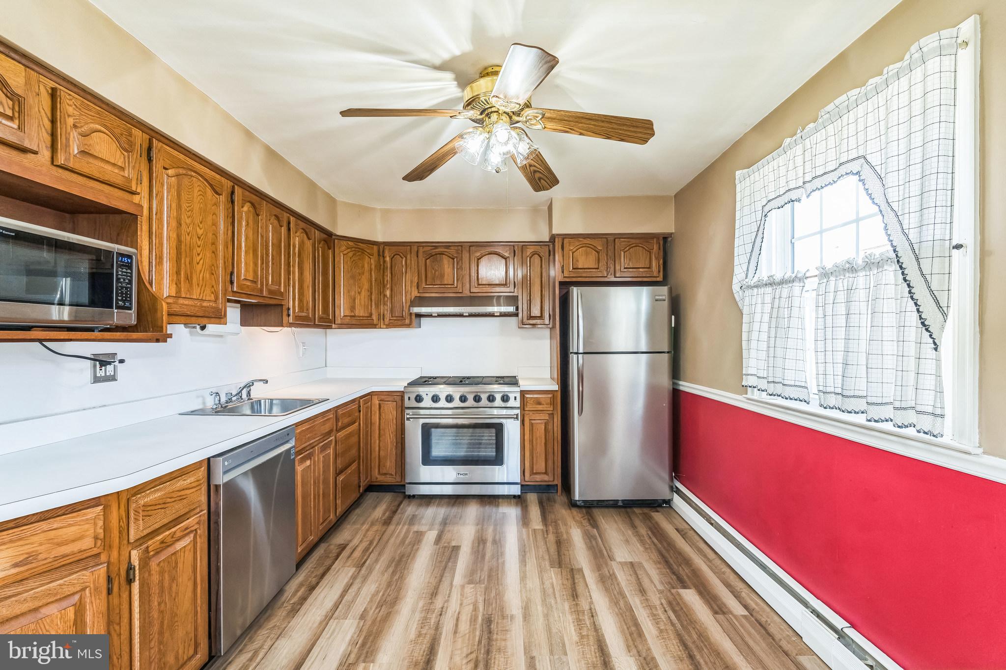 855 Medway Road Philadelphia, PA 19115 - Photo 9 of 30 a kitchen with stainless steel appliances granite countertop a stove cabinets a sink and a refrigerator