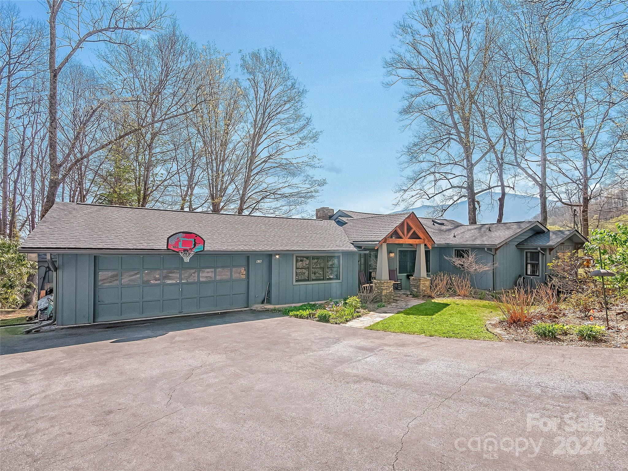 436 Old Fiddle Road Waynesville, NC 28786 - Photo 1 of 18 a front view of a house with a yard and garage