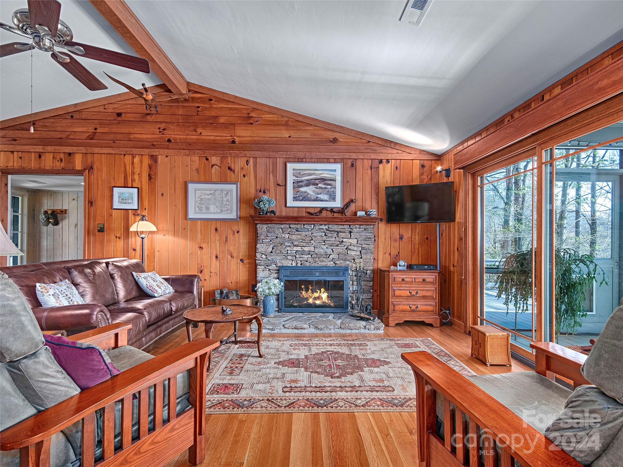 436 Old Fiddle Road Waynesville, NC 28786 - Photo 3 of 18 a living room with furniture a fireplace and a floor to ceiling window