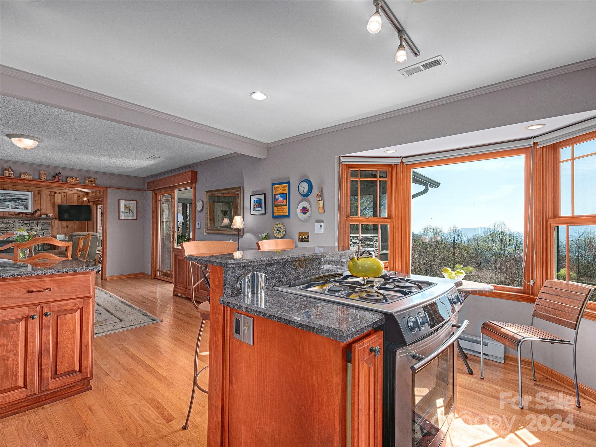 436 Old Fiddle Road Waynesville, NC 28786 - Photo 8 of 18 a table and chairs in a room with kitchen view