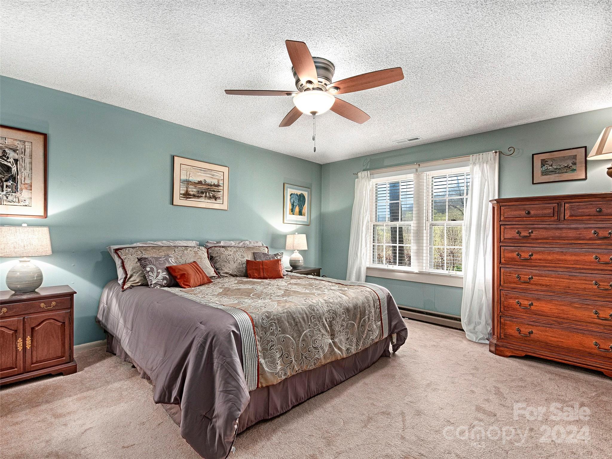 436 Old Fiddle Road Waynesville, NC 28786 - Photo 10 of 18 a bedroom with a bed a dresser and a window
