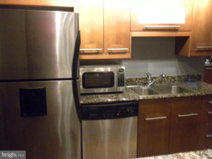 14409 Sturtevant Road Silver Spring, MD 20905 - Photo 16 of 30 a kitchen with a sink and a refrigerator
