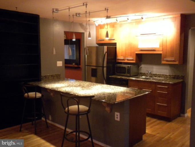 14409 Sturtevant Road Silver Spring, MD 20905 - Photo 17 of 30 a kitchen with a table and chairs