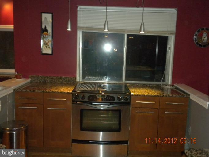 14409 Sturtevant Road Silver Spring, MD 20905 - Photo 18 of 30 a stove top oven sitting inside of a kitchen