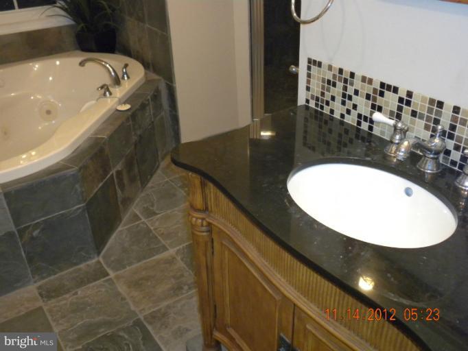 14409 Sturtevant Road Silver Spring, MD 20905 - Photo 25 of 30 a bathroom with a sink and mirror