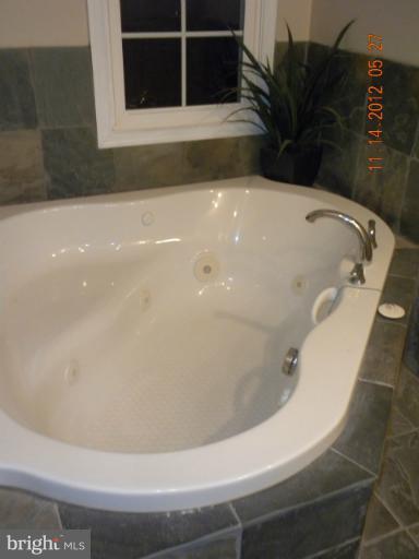 14409 Sturtevant Road Silver Spring, MD 20905 - Photo 28 of 30 a white bath tub sitting in a bathroom