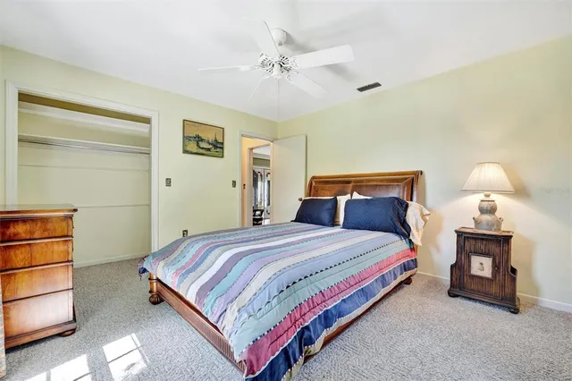 a bedroom with a bed and a ceiling fan