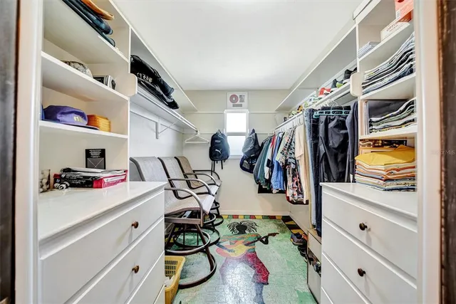 a view of walk in closet with clothes and shoes