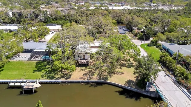 an aerial view of a house with a yard and lake view