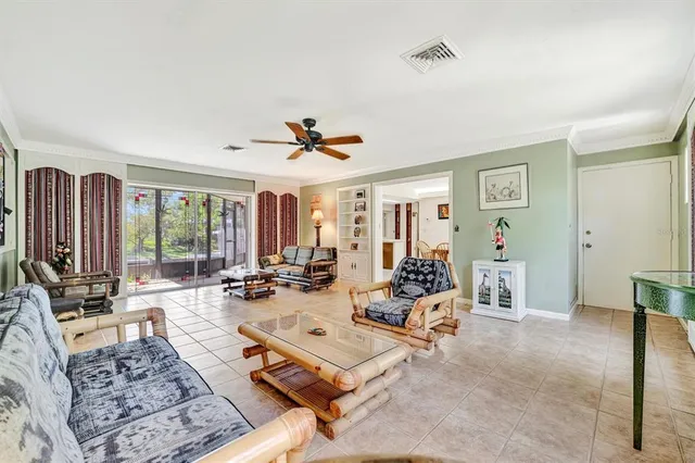 a living room with furniture and large windows