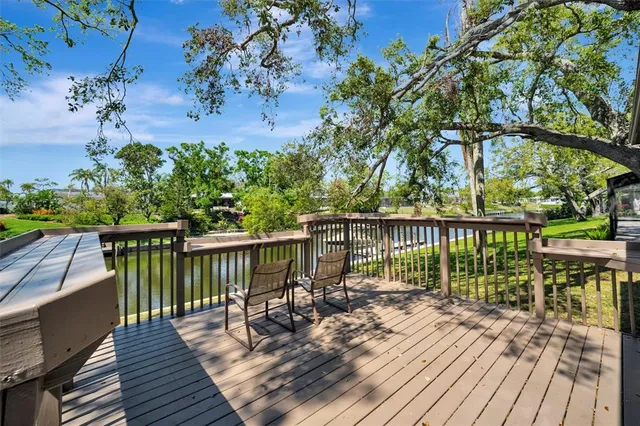 a view of balcony with wooden floor and fence