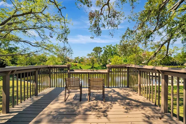 a balcony with wooden floor and fence