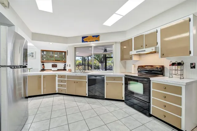 a kitchen with a stove top oven sink and cabinets