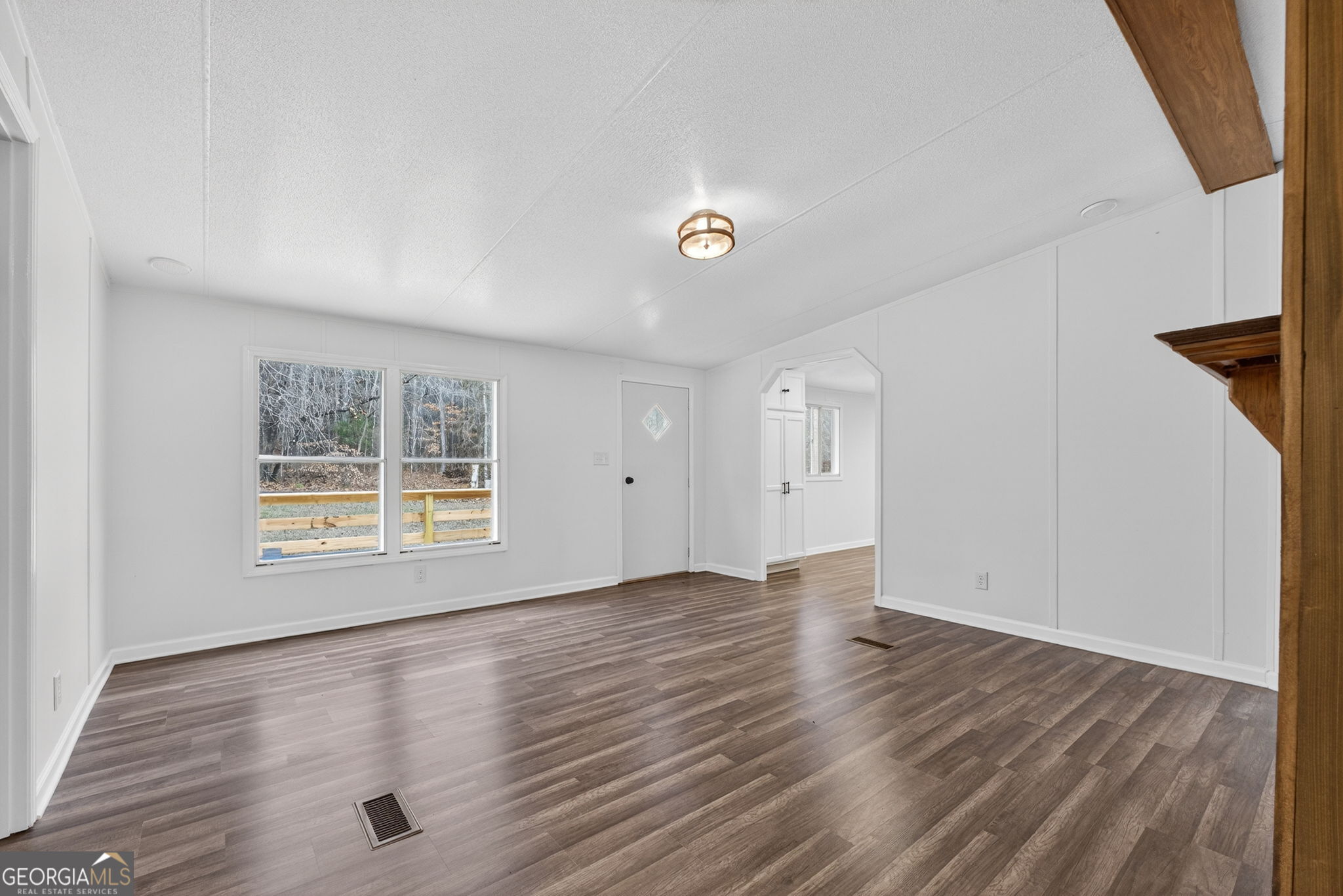 459 Hay Road Meansville, GA 30256 - Photo 11 of 36 an empty room with wooden floor and windows