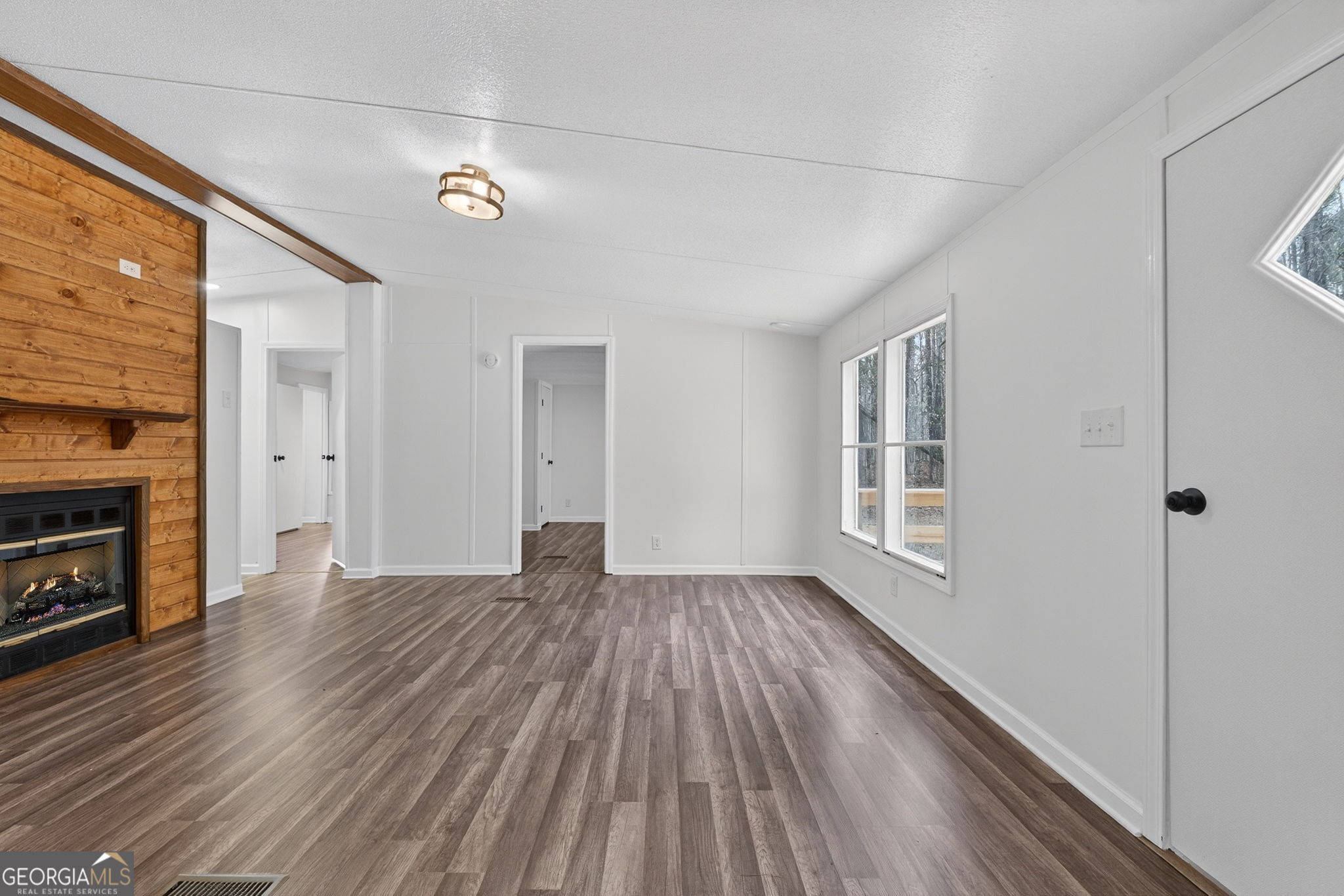459 Hay Road Meansville, GA 30256 - Photo 12 of 36 a view of an empty room with wooden floor and a window
