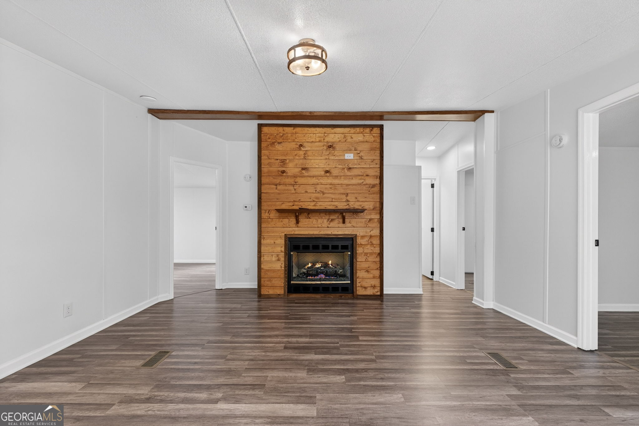 459 Hay Road Meansville, GA 30256 - Photo 13 of 36 a view of an empty room with wooden floor fireplace and a window