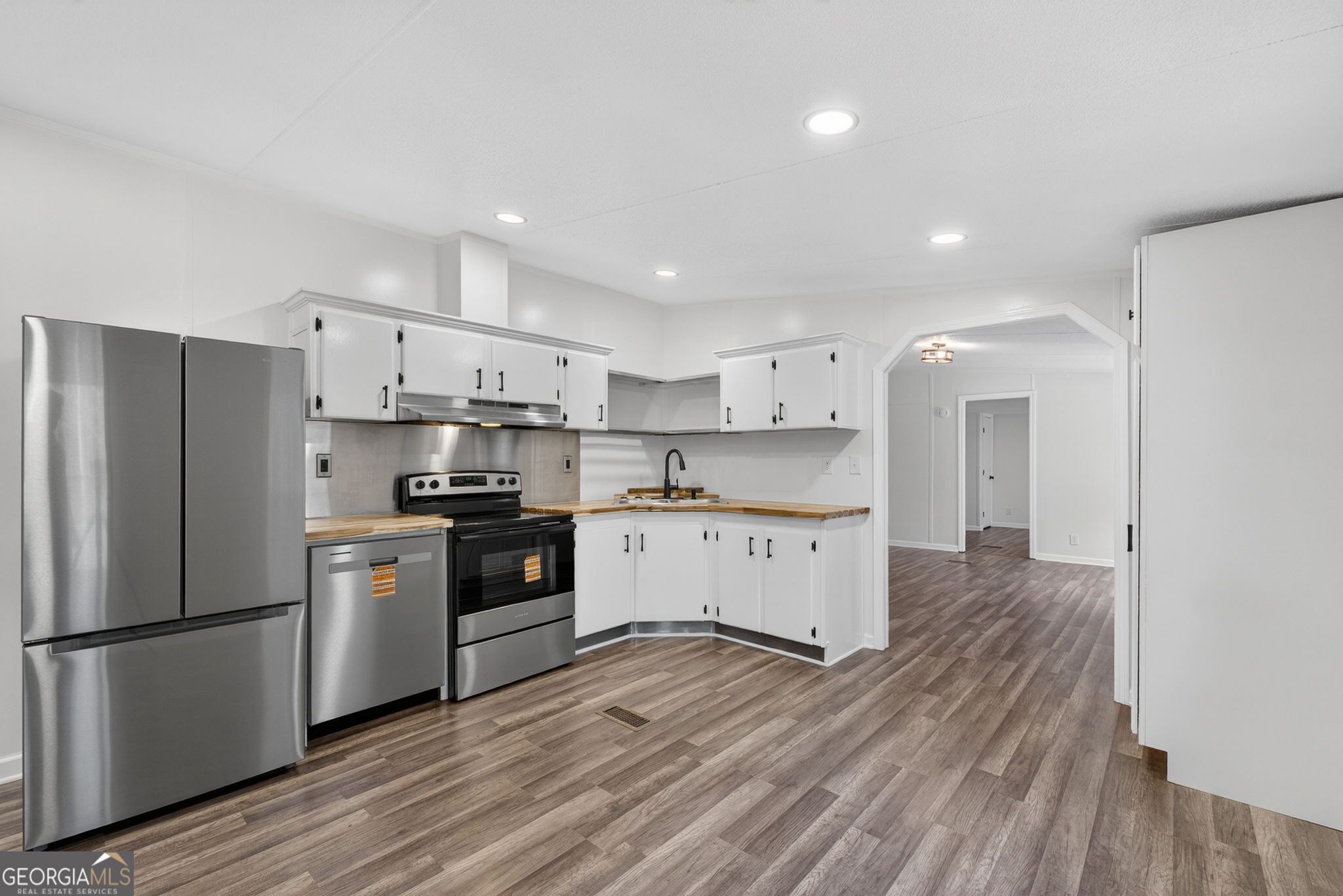 459 Hay Road Meansville, GA 30256 - Photo 15 of 36 a kitchen with a refrigerator a sink and cabinets