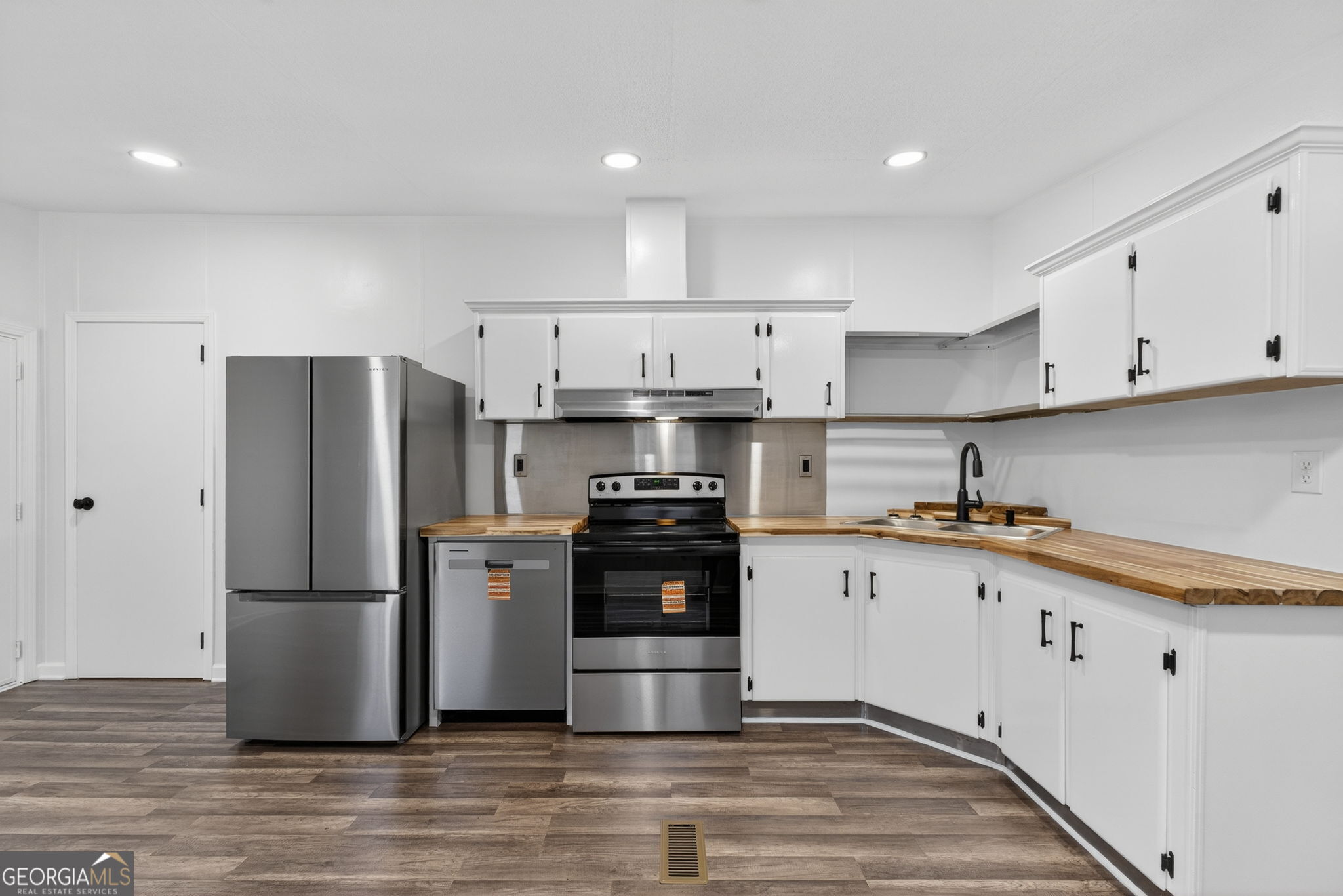 459 Hay Road Meansville, GA 30256 - Photo 16 of 36 a kitchen with granite countertop white cabinets and stainless steel appliances
