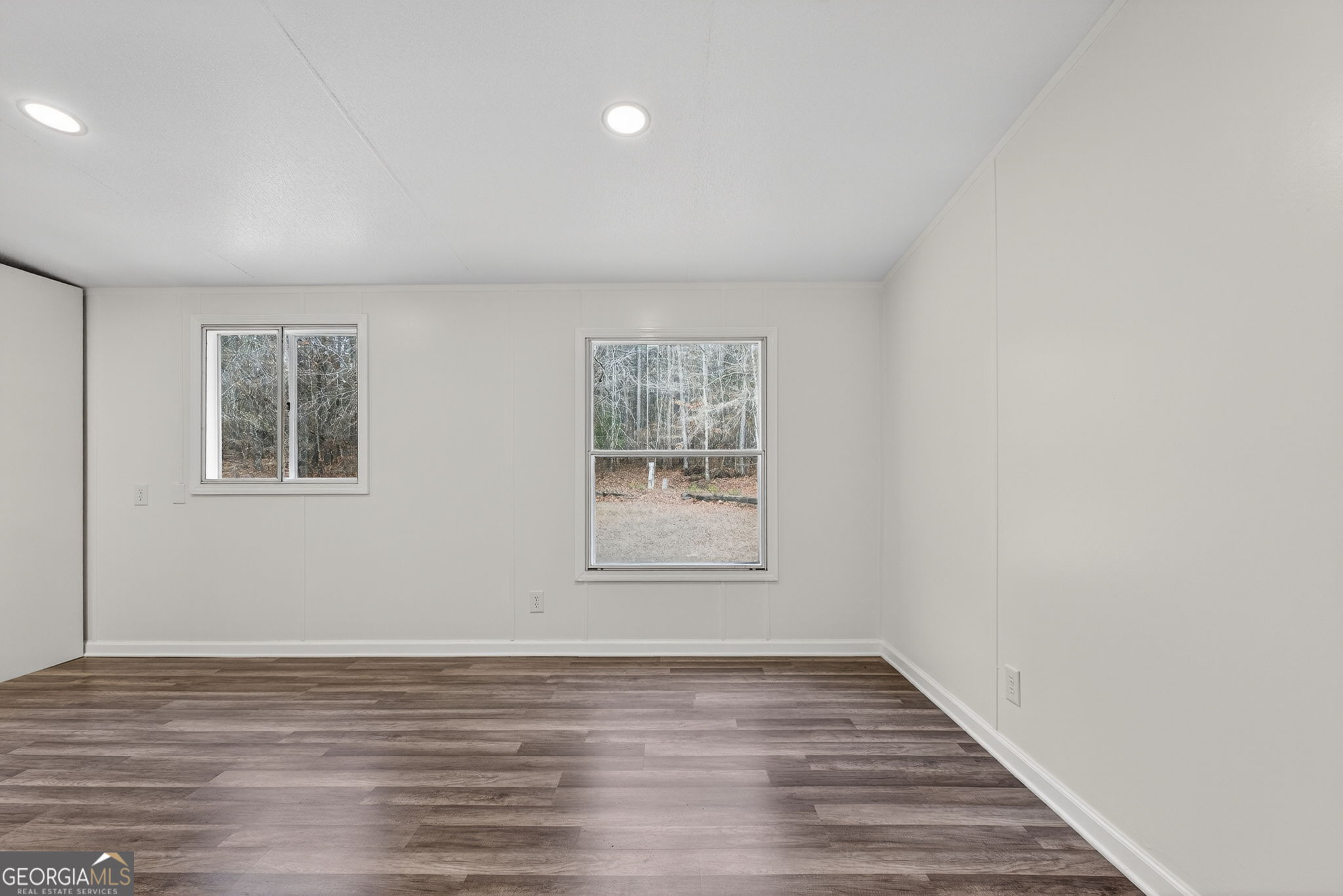 459 Hay Road Meansville, GA 30256 - Photo 17 of 36 a view of an empty room with wooden floor and a window