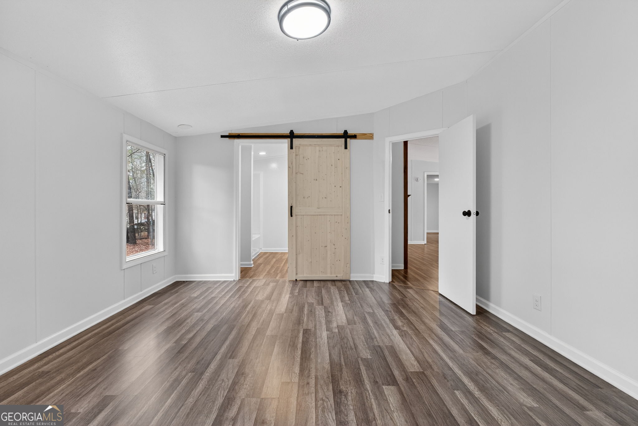 459 Hay Road Meansville, GA 30256 - Photo 20 of 36 an empty room with wooden floor and windows