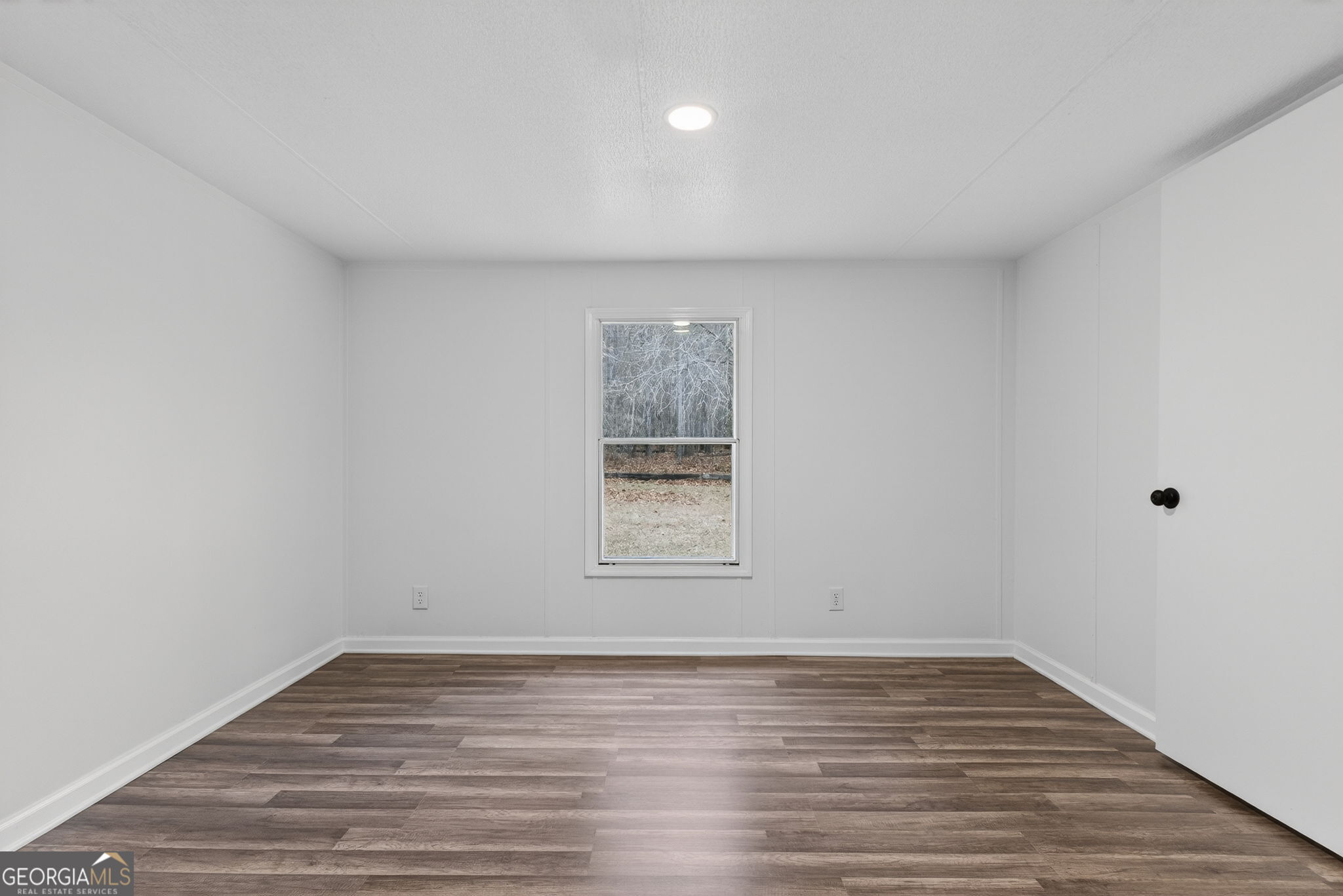459 Hay Road Meansville, GA 30256 - Photo 26 of 36 a view of an empty room with wooden floor and a window