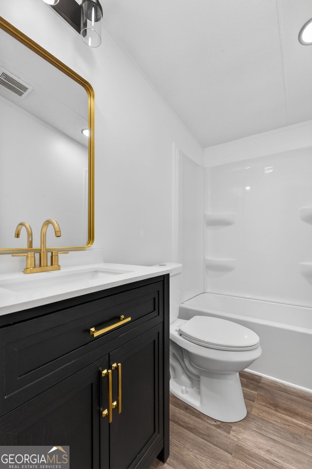 459 Hay Road Meansville, GA 30256 - Photo 28 of 36 a bathroom with a sink a toilet a mirror and shower