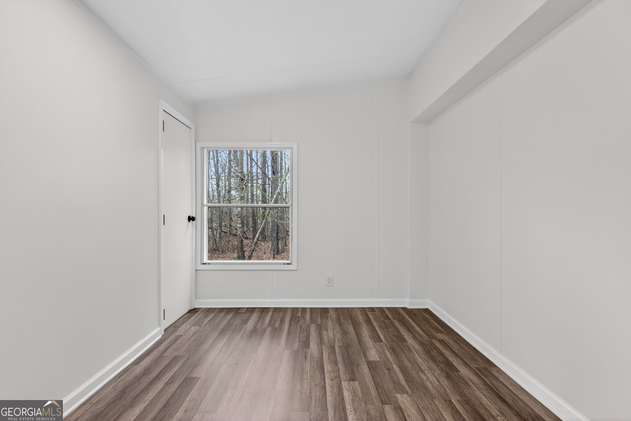 459 Hay Road Meansville, GA 30256 - Photo 29 of 36 a view of an empty room with wooden floor and a window