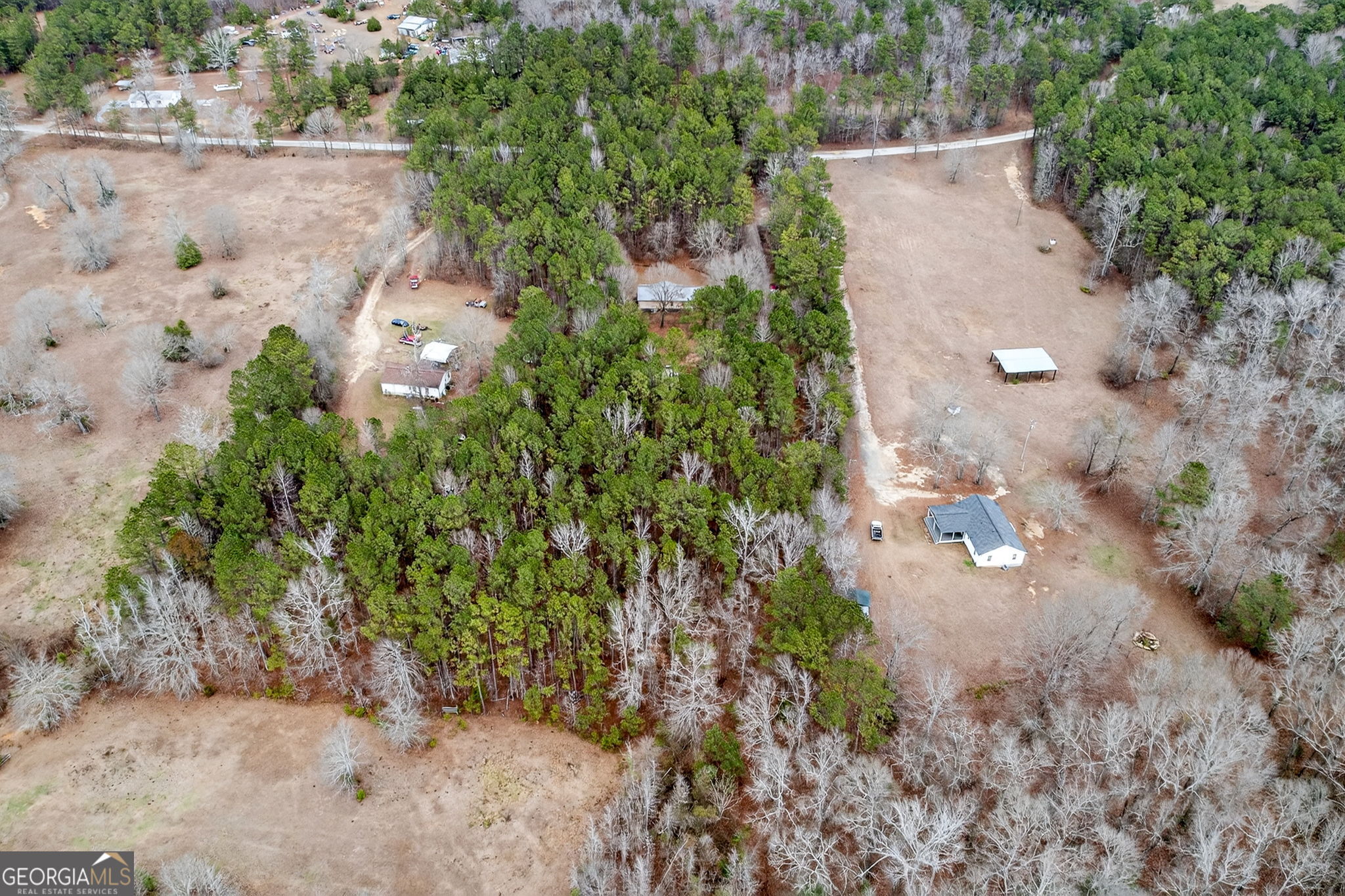 459 Hay Road Meansville, GA 30256 - Photo 34 of 36 an aerial view of a house with a yard and trees all around