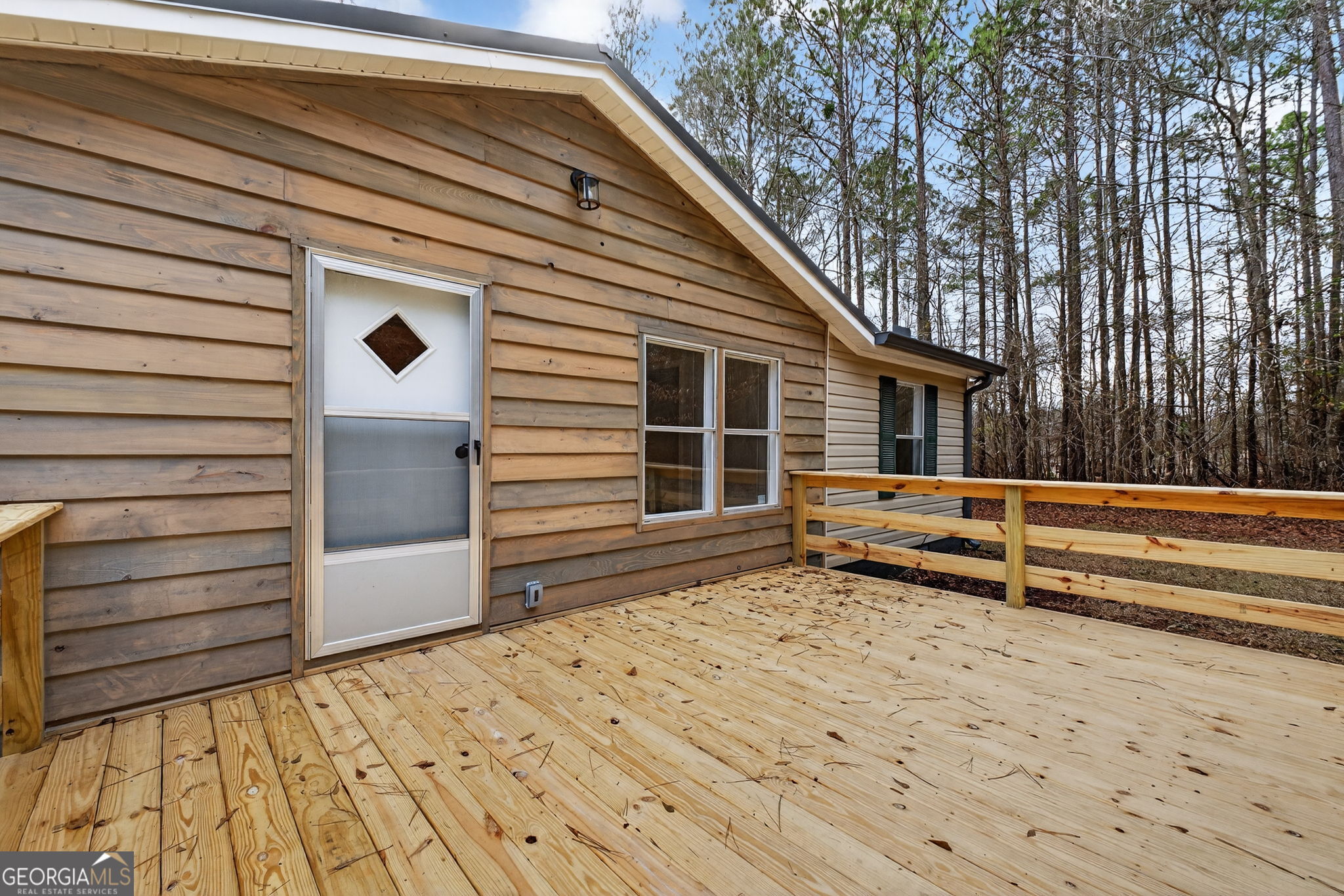 459 Hay Road Meansville, GA 30256 - Photo 5 of 36 a view of a house with a wooden fence