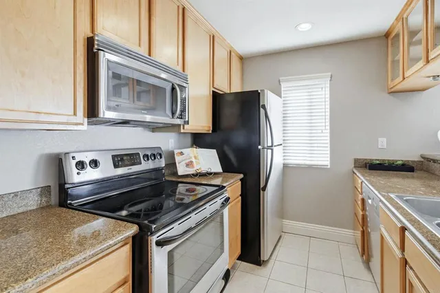 a kitchen with a sink and a wooden floor