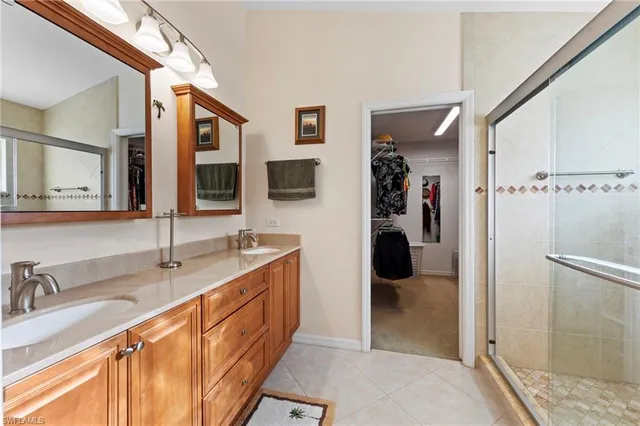 a bathroom with a double vanity sink and a mirror