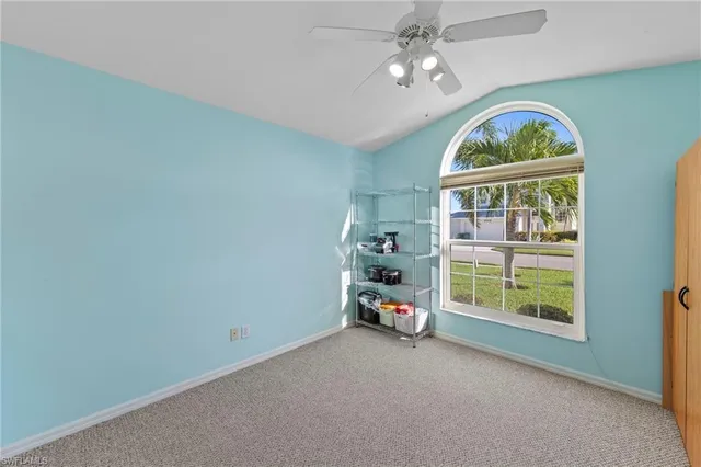 an empty room with windows and chandelier